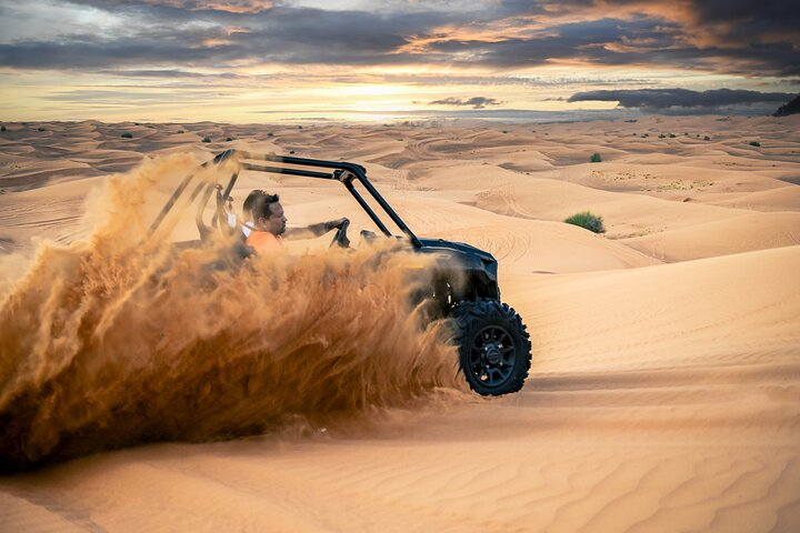 Experience the stunning Red Dunes of Al Lahbab as you navigate your self-drive buggy followed by a camel ride and a flavorful BBQ dinner under the desert sky.